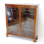 A reproduction mahogany 2-door bookcase, with glazed panelled doors, and 3 adjustable shelves,