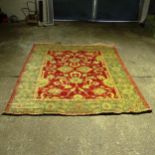 A large green ground Persian design carpet, with red ground lozenge, 358cm x 276cm (Viewing by