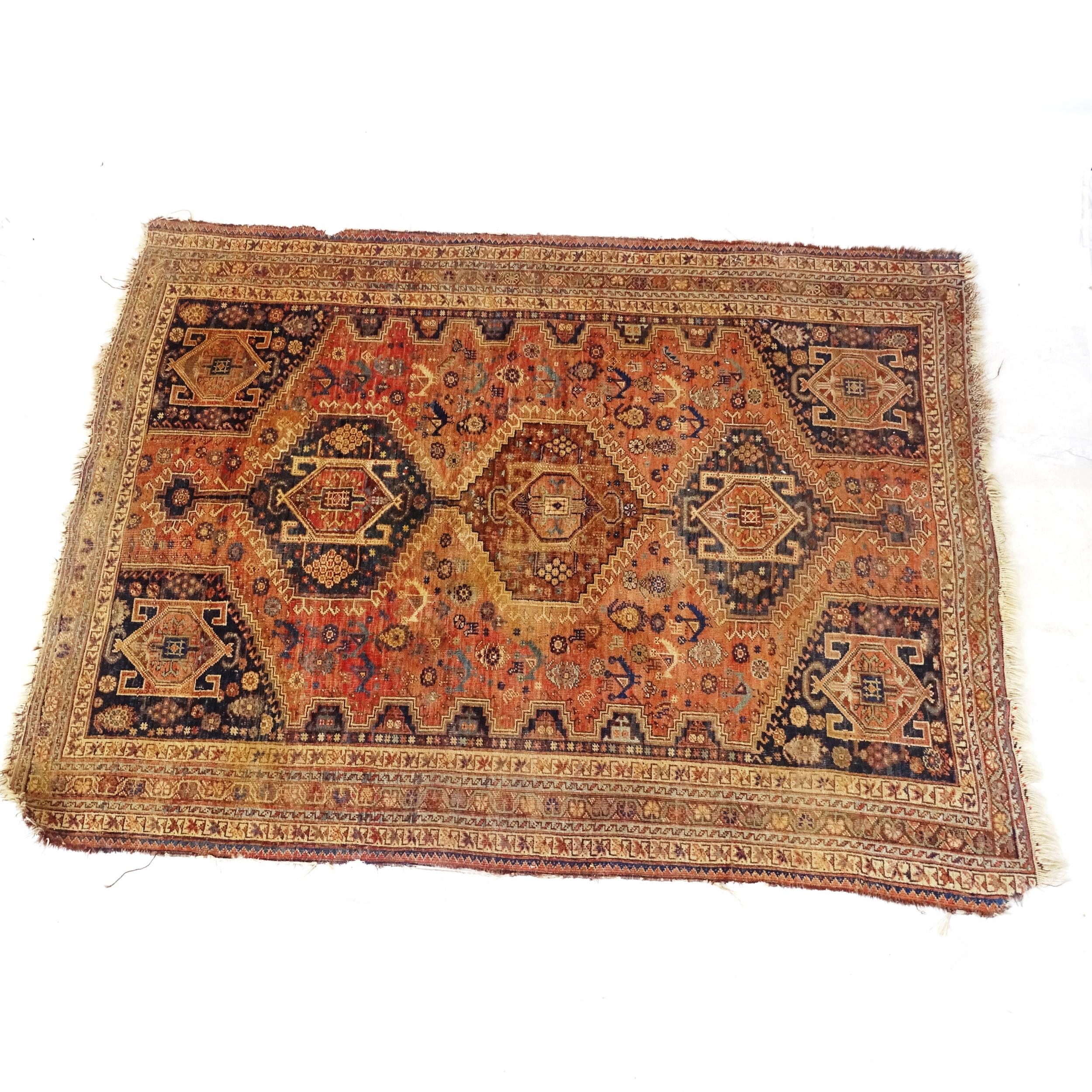 An Antique red ground Persian rug, with 5 symmetrical panel border and lozenge, 200cm x 150cm