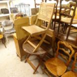 A small circular slatted folding garden table, and a pair of matching folding garden chairs