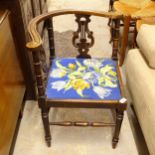 An Edwardian bow-arm corner chair