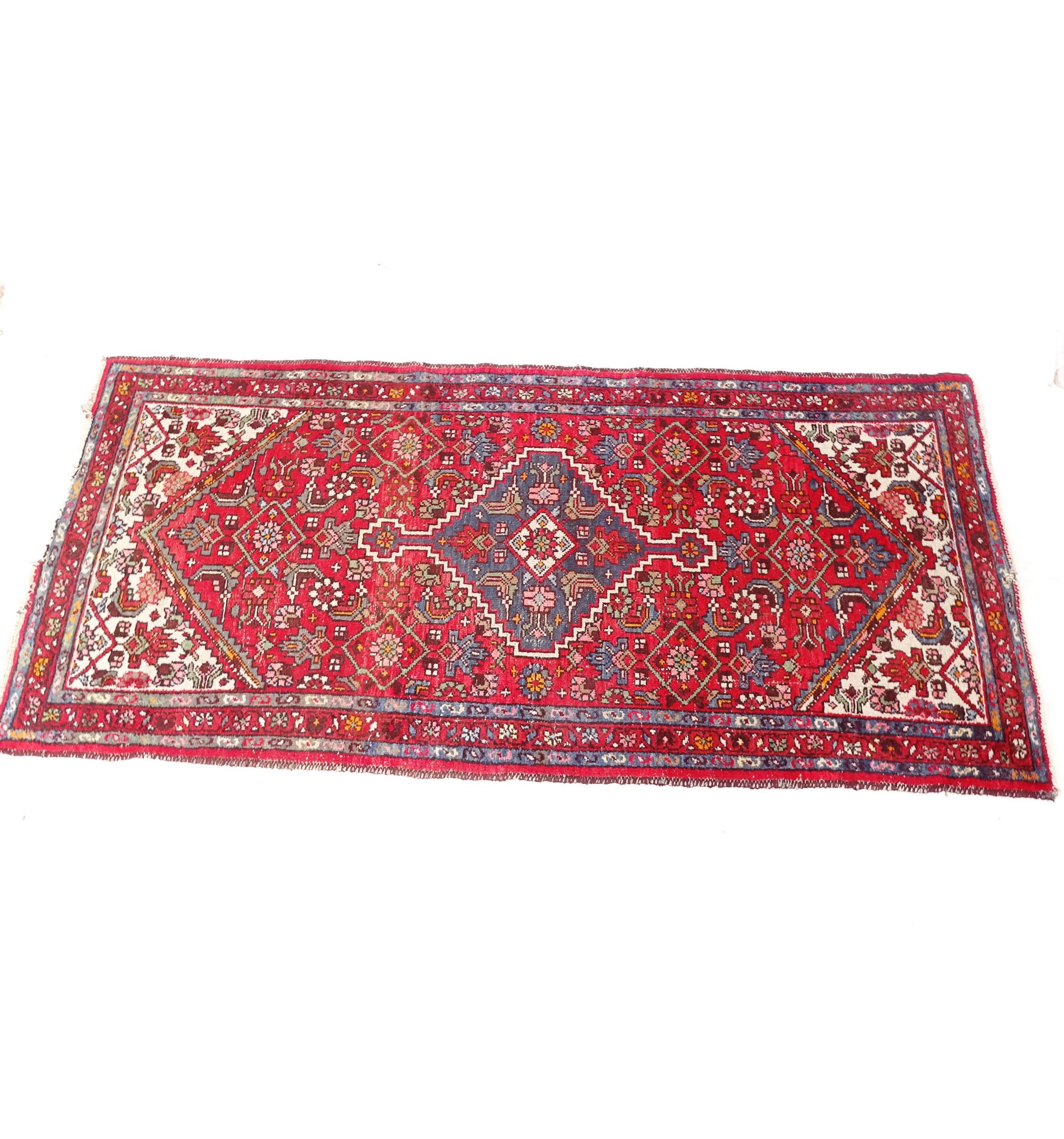 A red ground Persian design runner, 220cm x 108cm