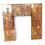 A highly stylised Victorian Art Nouveau studded copper fire surround, with raised embossed