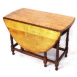 An oak oval gateleg table, on baluster turned legs, W105cm, H73cm