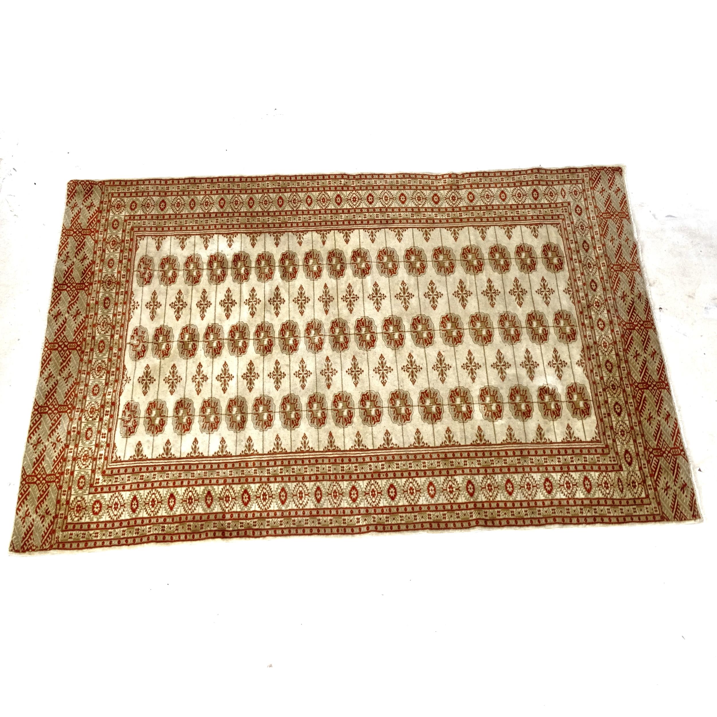A cream ground wool Tekke design rug, 195cm x 130cm