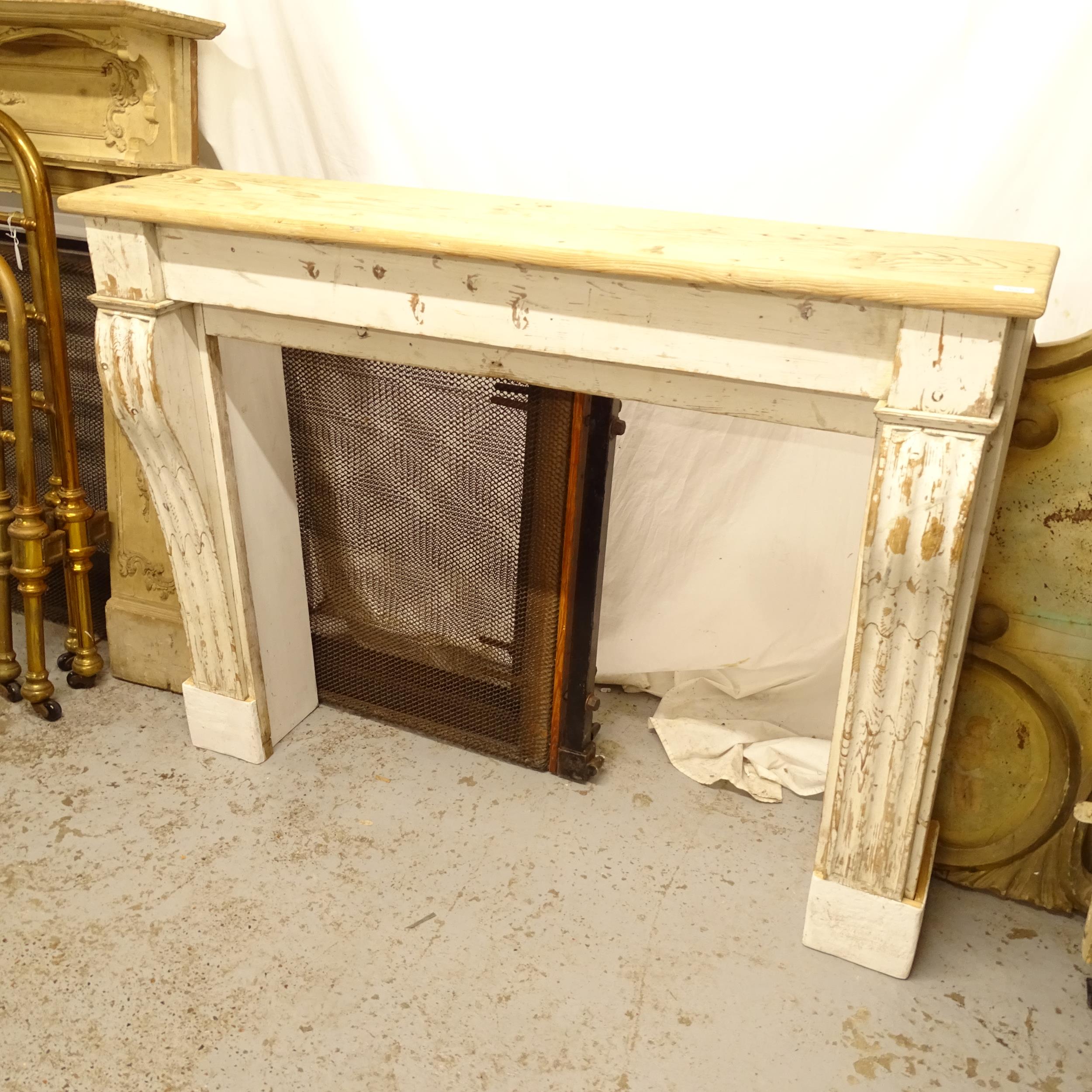 A painted pine fire surround, W135cm, H105cm, D30cm, rebate width 107cm and height 83cm