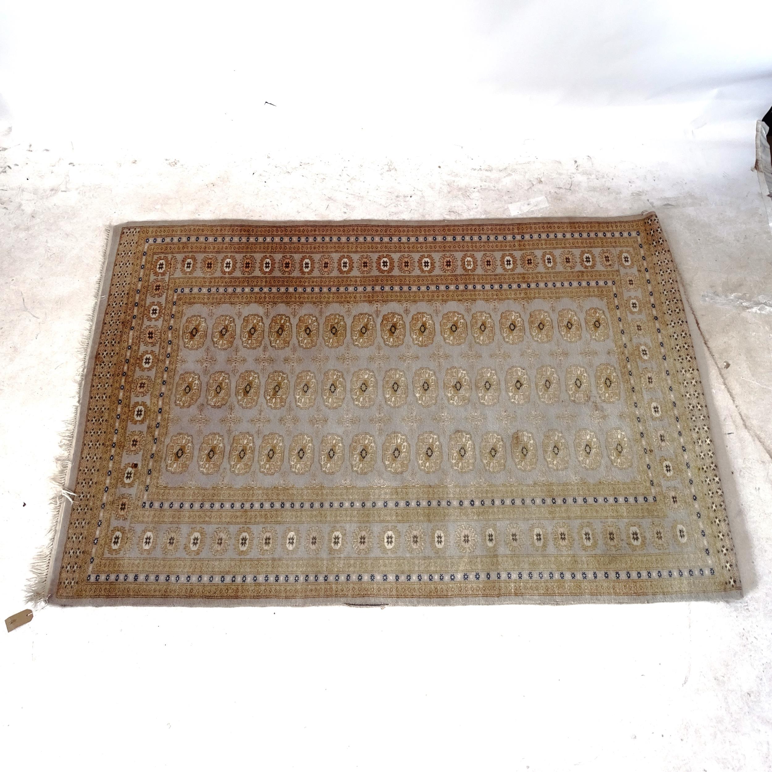 A Tekke design rug, with symmetrical border, 187cm x 126cm