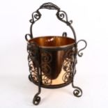 A copper coal bucket in wrought-iron stand, height 59cm overall