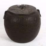 A Chinese cast-iron pot, with embossed decoration, height 19cm