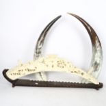 A composition ivory-effect bridge, and a pair of cow horns, 55cm