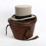 A Victorian grey top hat, by Army & Navy Stores Ltd, in brown leather travelling case