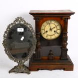 A 2-train mantel clock with pendulum, height 39cm, and a small swing toilet mirror, in cast-metal