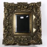 A modern ornate bevel-edge wall mirror, overall 52cm x 47cm