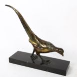 An Art Deco style patinated spelter sculpture, prowling pheasant, unsigned, on black slate base,