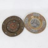 A Buddhist silver and copper overlaid brass roundel plaque, and an Eastern brass stone set dish,