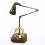 A Vintage industrial green anglepoise bench lamp, with white enamel shade