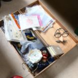 A box containing football memorabilia, a bugle, dolls etc