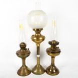 A Vintage brass oil lamp, with etched frosted glass shade and chimney, height 70cm, and a pair of