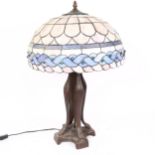A reproduction Tiffany style leadlight table lamp, with lion paw base, overall height 62cm, shade
