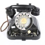 A large Vintage black Bakelite dial telephone, with enamel dial