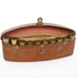 A 19th century curved tan leather 10-section shotgun cartridge case, with embossed crest and empty