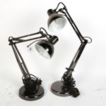 A pair of modern black chrome anglepoise desk lamps