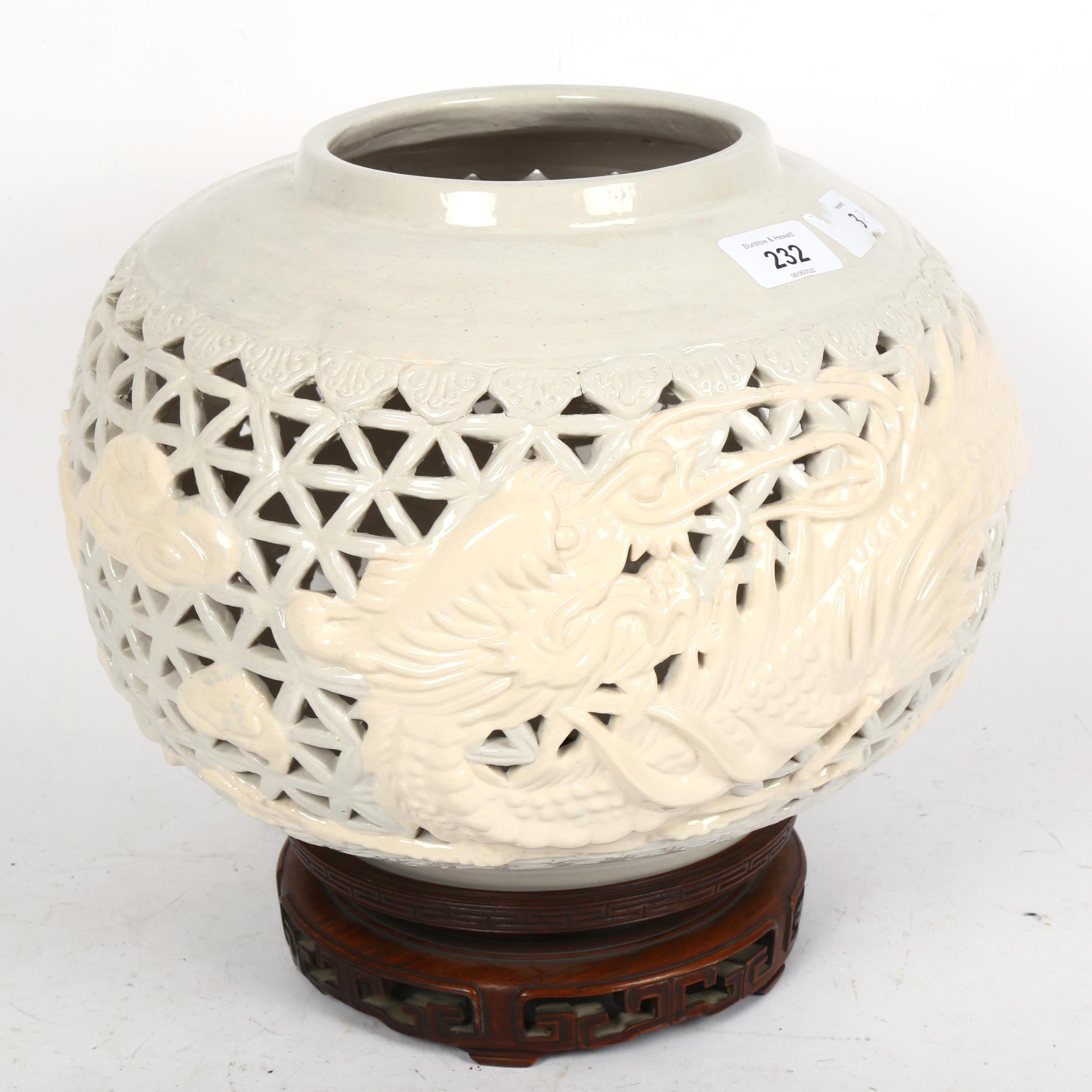 A Chinese Nan Yang ceramic lamp base, and carved hardwood stand, overall height 27cm