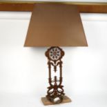 A weathered cast-iron table lamp on stone base with shade, overall height 95cm