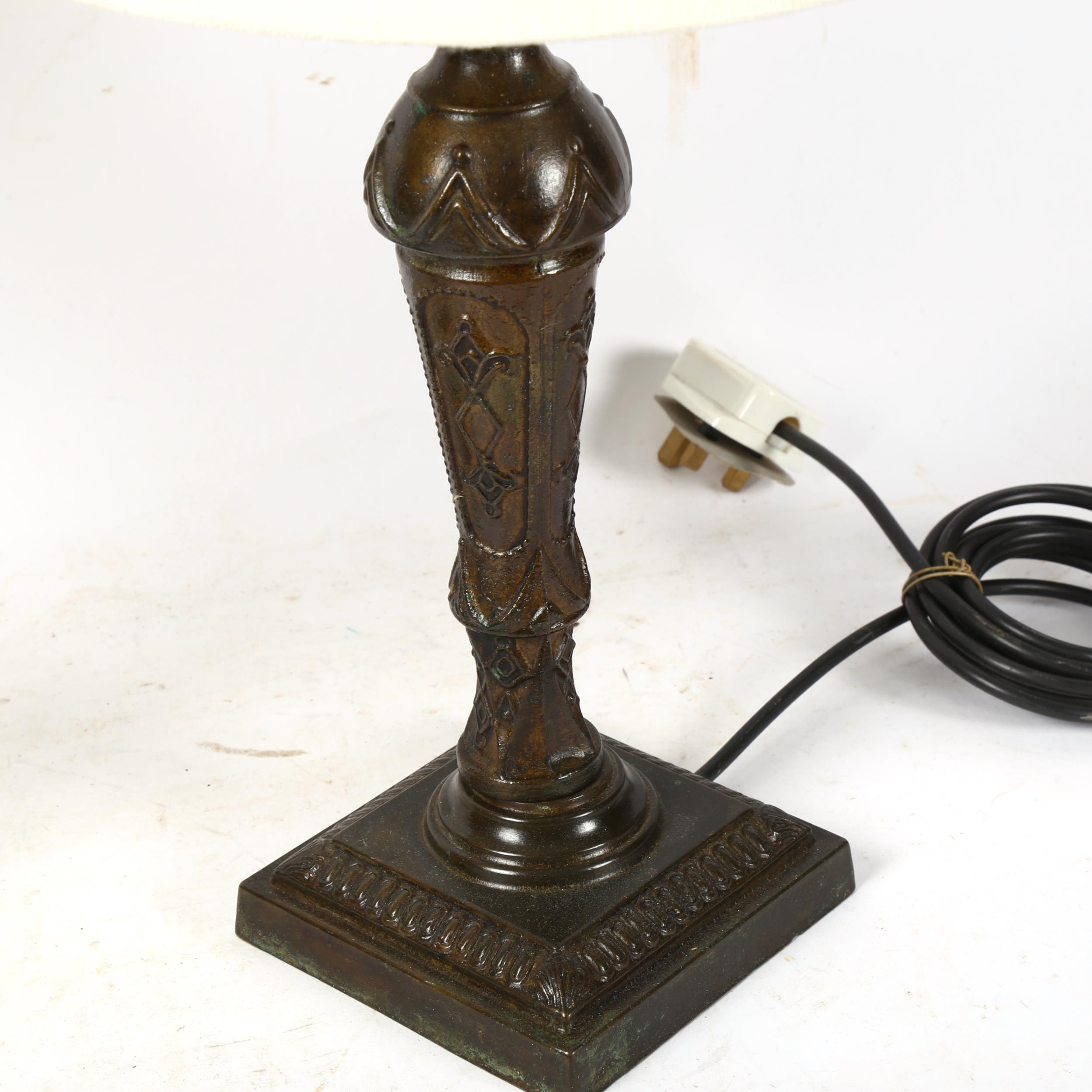 A pair of patinated cast-brass table lamps, in Classical design, with cream shades, height 44cm - Image 2 of 2