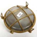 A modern cast-brass bulk-head wall lamp, diameter 23cm