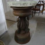 A heavy cast-iron water fountain with heron adorned column and stone topper.