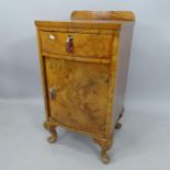 A burr-walnut bow-front bedside cupboard, with single drawer on carved cabriole legs, 42cm x 81cm