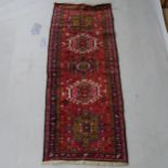 A small red ground Afghan runner, 190cm x 70cm