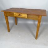 An early 20th century pine-top writing table, with single fitted drawer, on square tapered legs,