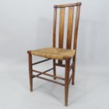 A Liberty style Art Nouveau beech sided chair, with inlaid back and rush seat, overall height 85cm