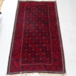 A red ground Afghan design rug with symmetrical pattern, 185cm x 95cm