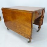 An Antique oak drop leaf dining table, with end frieze drawer, raised on baluster turned legs,