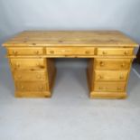 A modern pine twin-pedestal writing desk, with 9 fitted drawers, 154cm x 79cm x 79cm