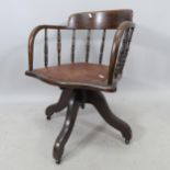 An American spindle-back bow-arm swivel desk chair, with studded seat