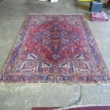 A red and blue ground Caucasian carpet, 385cm x 282cm (Viewing by appointment only for this Lot as