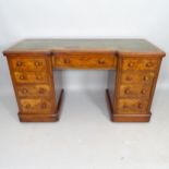 A Victorian walnut kneehole writing desk, with 9 fitted drawers and tooled and embossed green