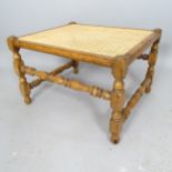 An Antique mahogany cane-seated footstool, 61cm x 40cm x 52cm