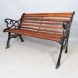 A stained teak slatted garden bench with cast-iron ends, L124cm