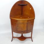A George III mahogany corner washstand, with raised back and drawer and cupboard under, 67cm x 122cm