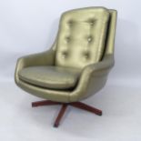 A mid-century upholstered swivel armchair