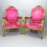 A pair of gilt painted French open arm chairs