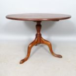 A Georgian mahogany circular tilt-top occasional table, 75cm x 55cm