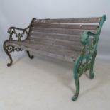 A weathered teak slatted garden bench with cast-iron ends, L130cm