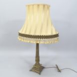 A brass Continental style Corinthian column table lamp fitted with twin bulbs, height to bayonet