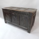 A 19th century panelled oak coffer, with carved linenfold decoration on stile legs, 126cm x 68cm x